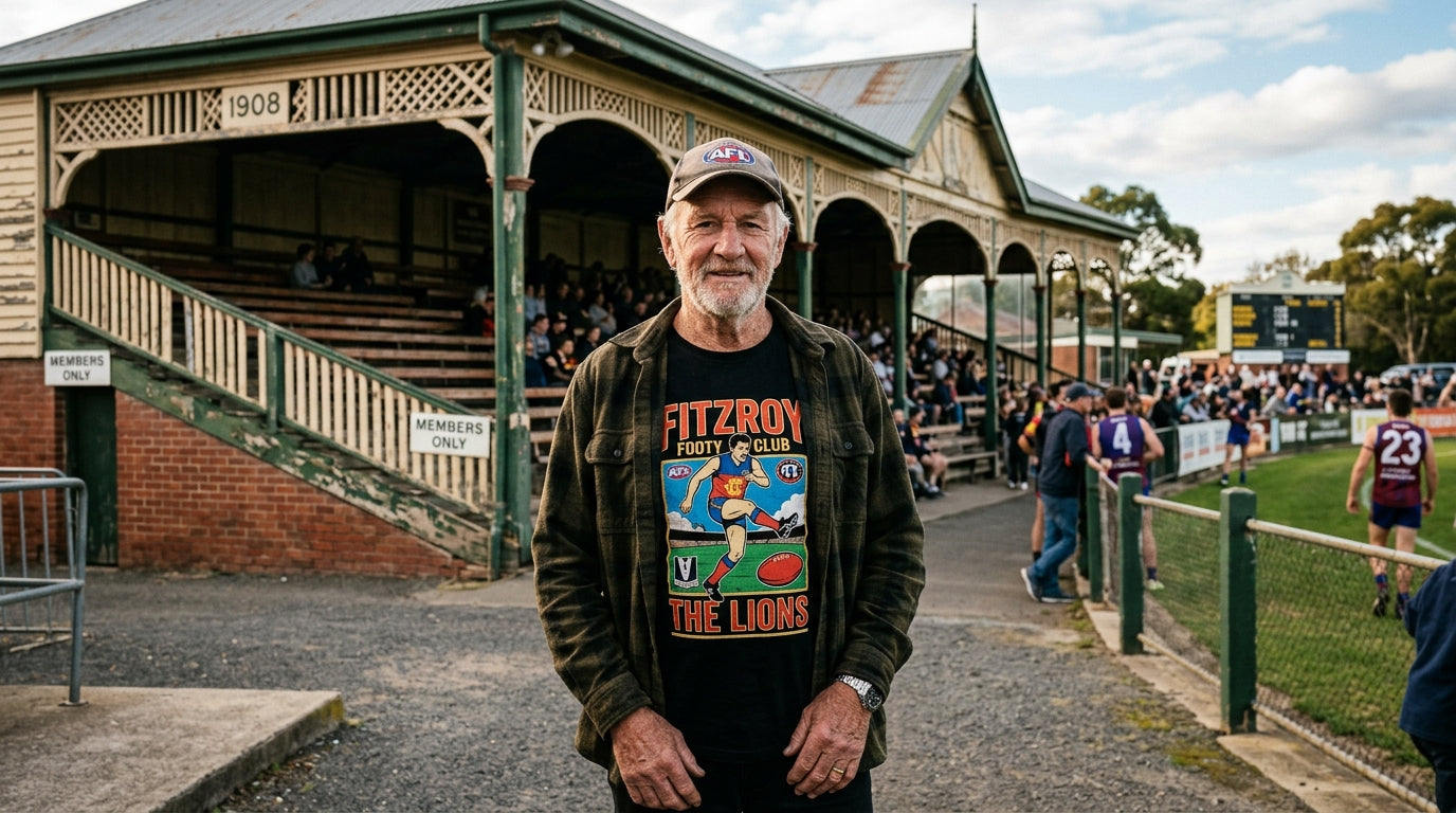 Australian man in graphic tee standing at a heritage Australian rules football ground